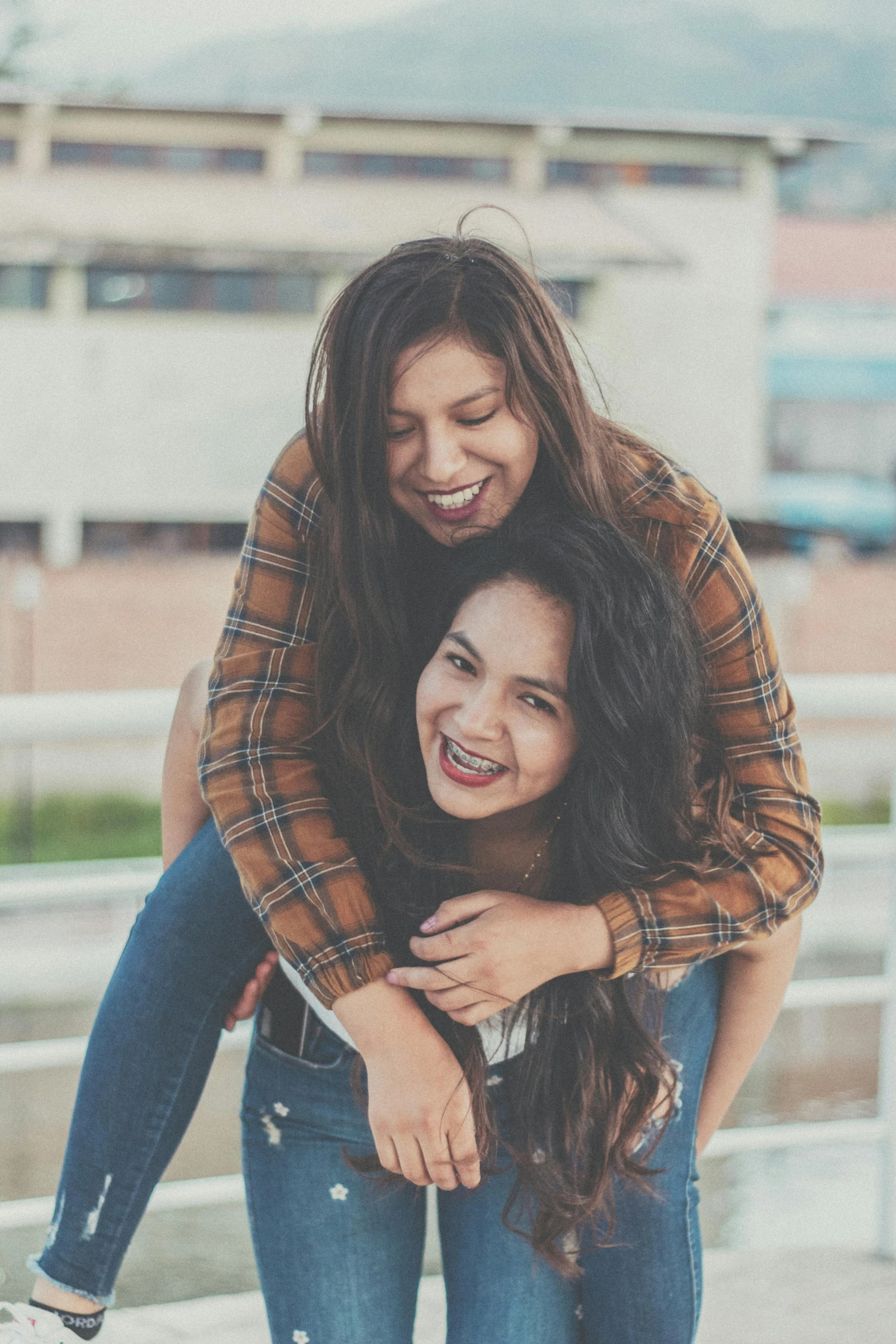 two girls hugging each other while one of them holds another girl