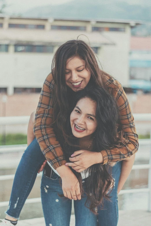 two girls hugging each other while one of them holds another girl