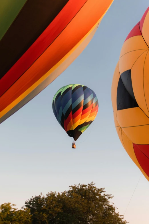 several colorful balloons in the sky next to each other