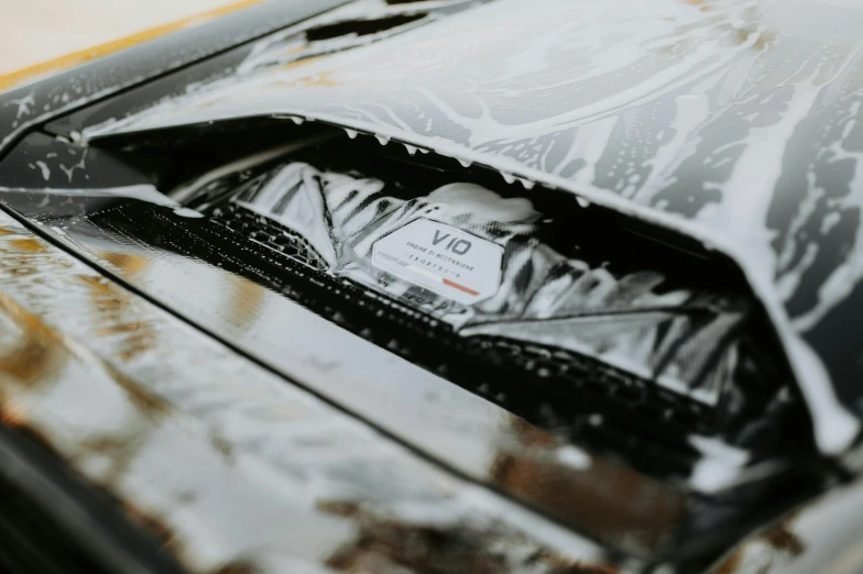 a black and white car has an orange tag