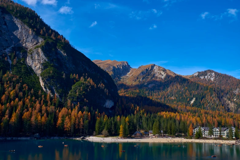 the mountains surround a lake near a forest