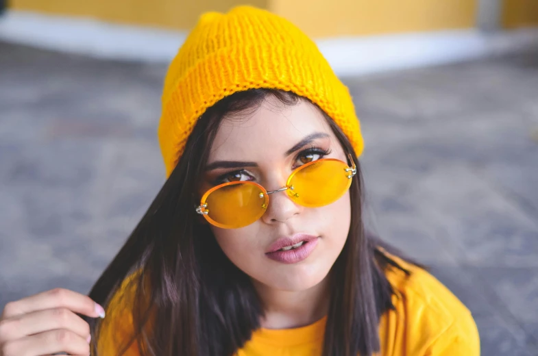 a woman wearing sunglasses and a hat