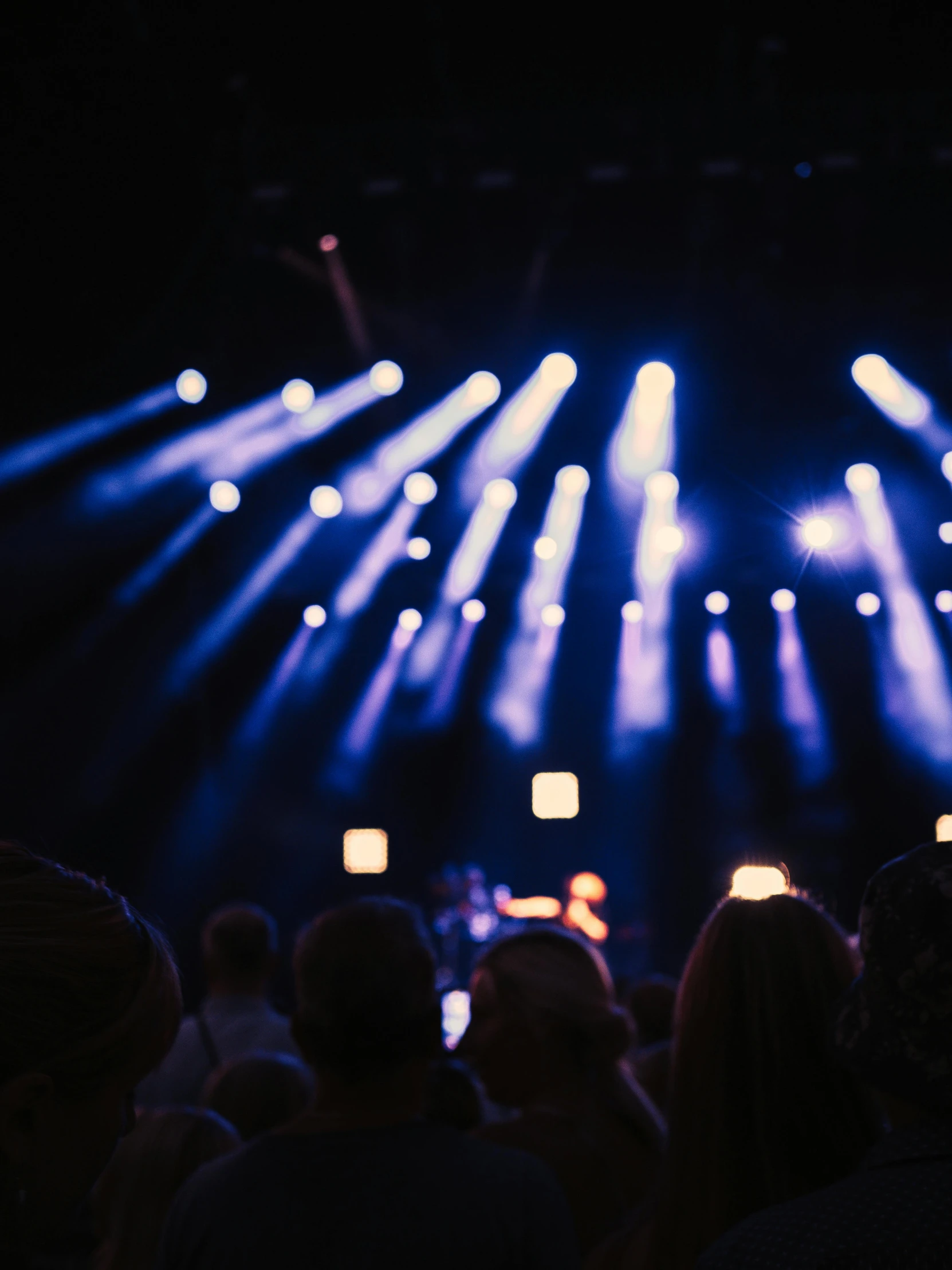 a big stage full of colorful lights that is blue