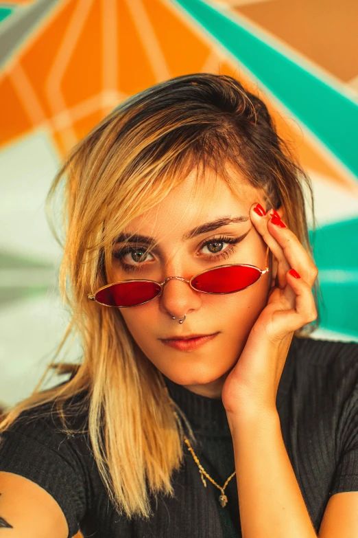 a girl with glasses is posing for the camera