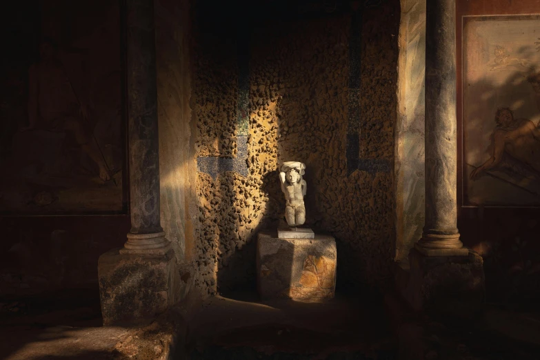 an ancient sculpture in a room with paintings and columns