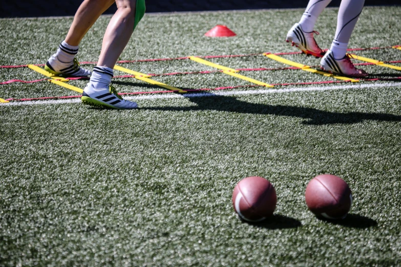 some people on a field with three balls