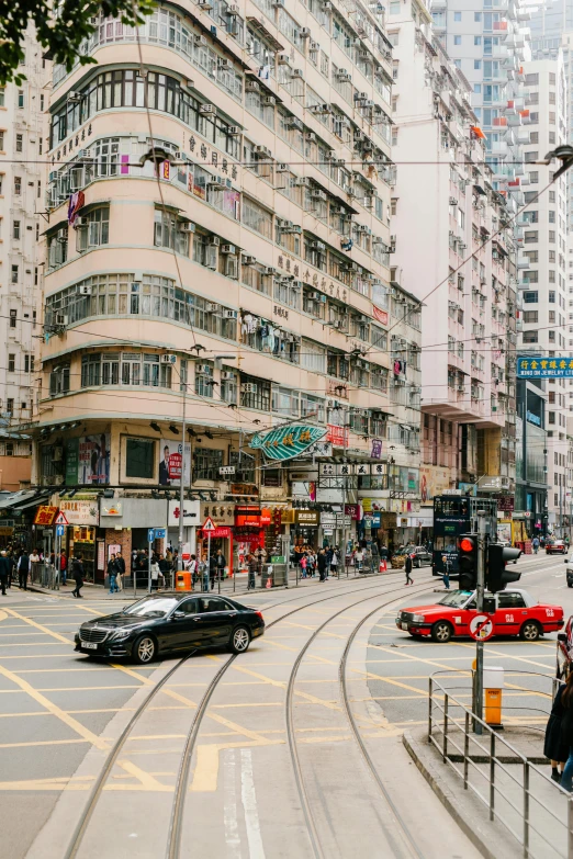 a city street is pictured with cars, people, and buildings