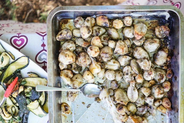 some food is sitting on a pan and some vegetables are still in the dish