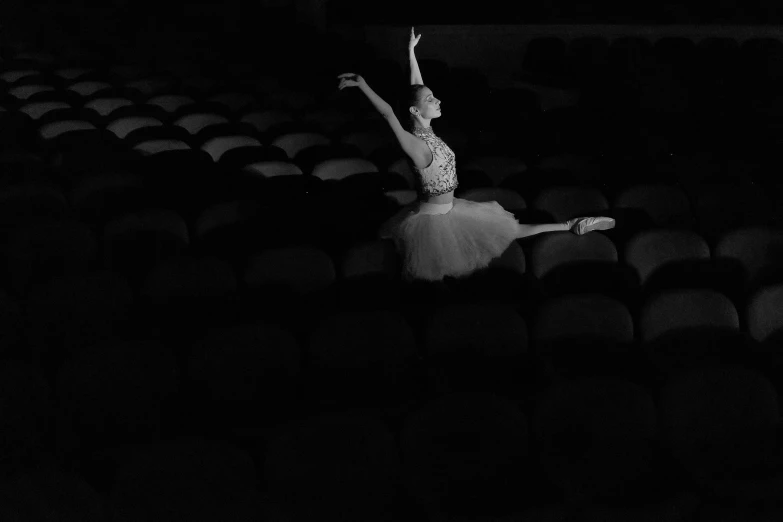 a dancer standing on the back of a seat