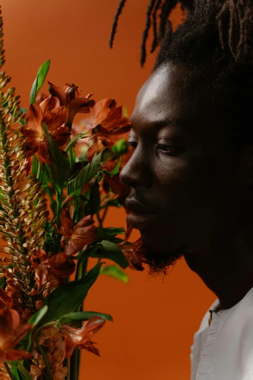 a man holding a bouquet of flowers in front of him