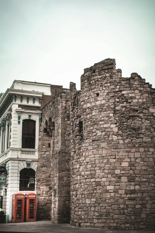 an old brick tower sitting near the front of a white building