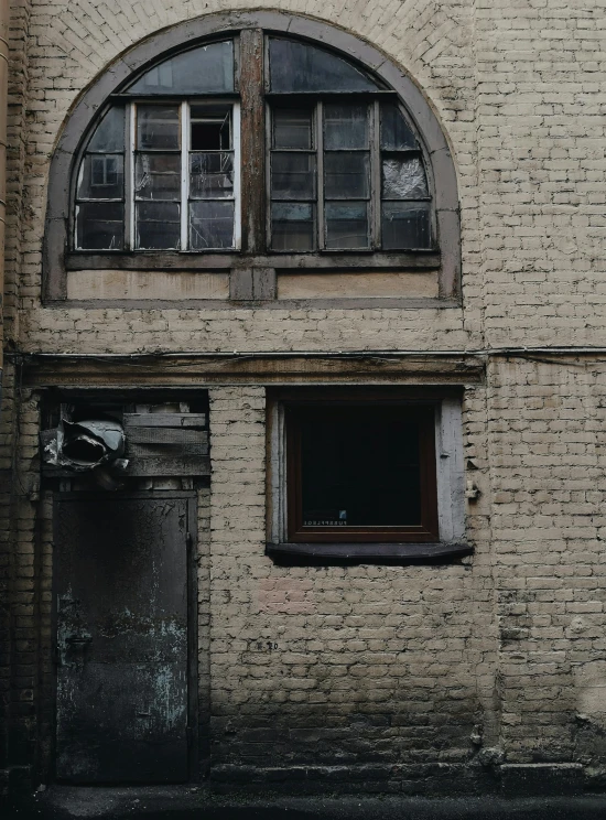 an open window sits in the corner of a brick building