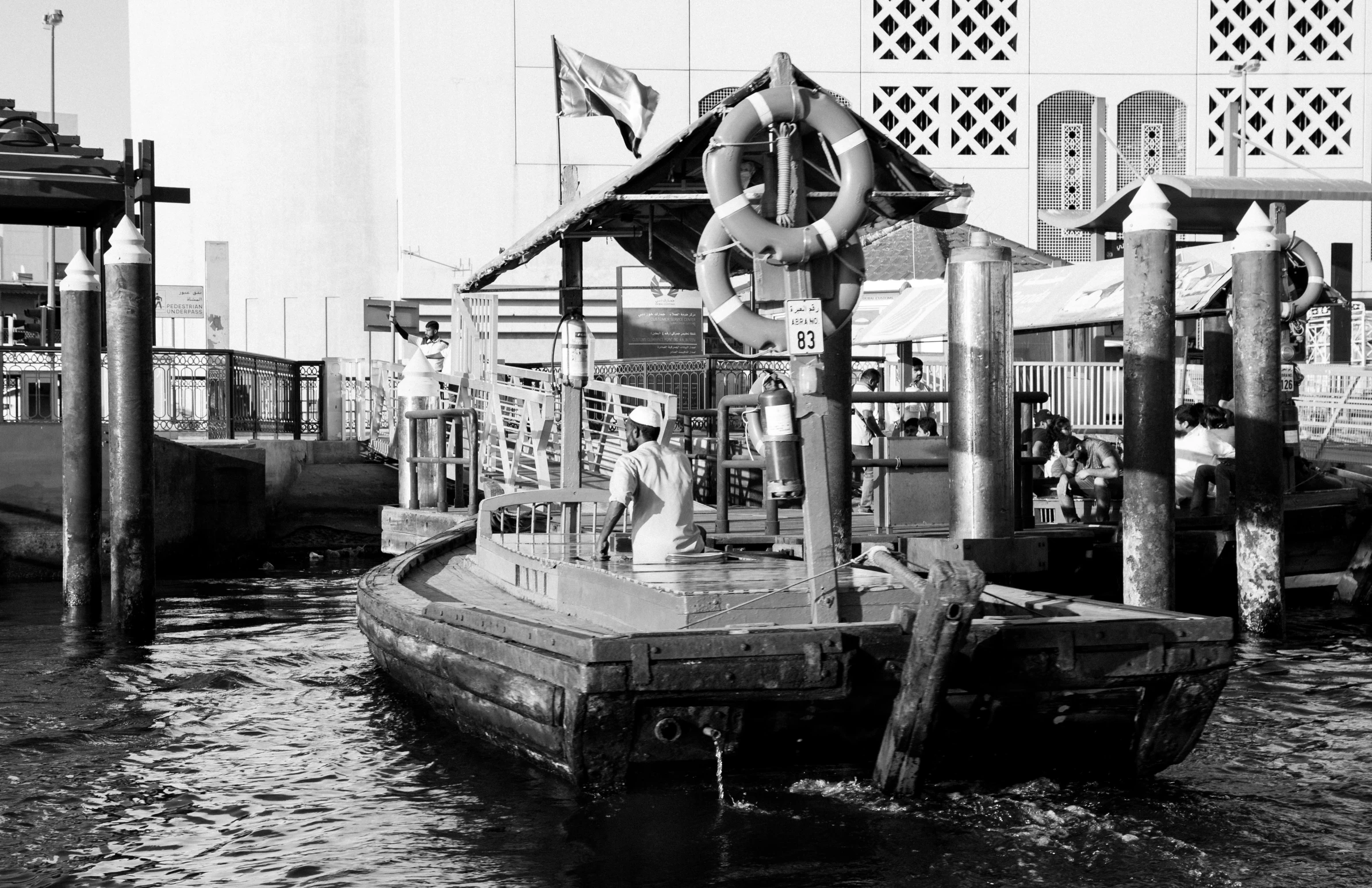 a man is standing on the back of a boat