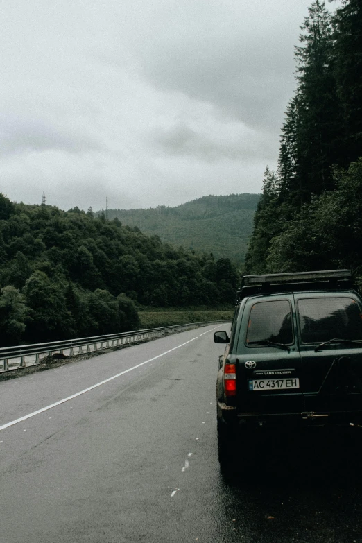 a car is riding up to a mountain pass