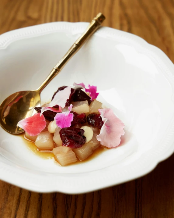 a white bowl filled with some assorted fruit and other foods