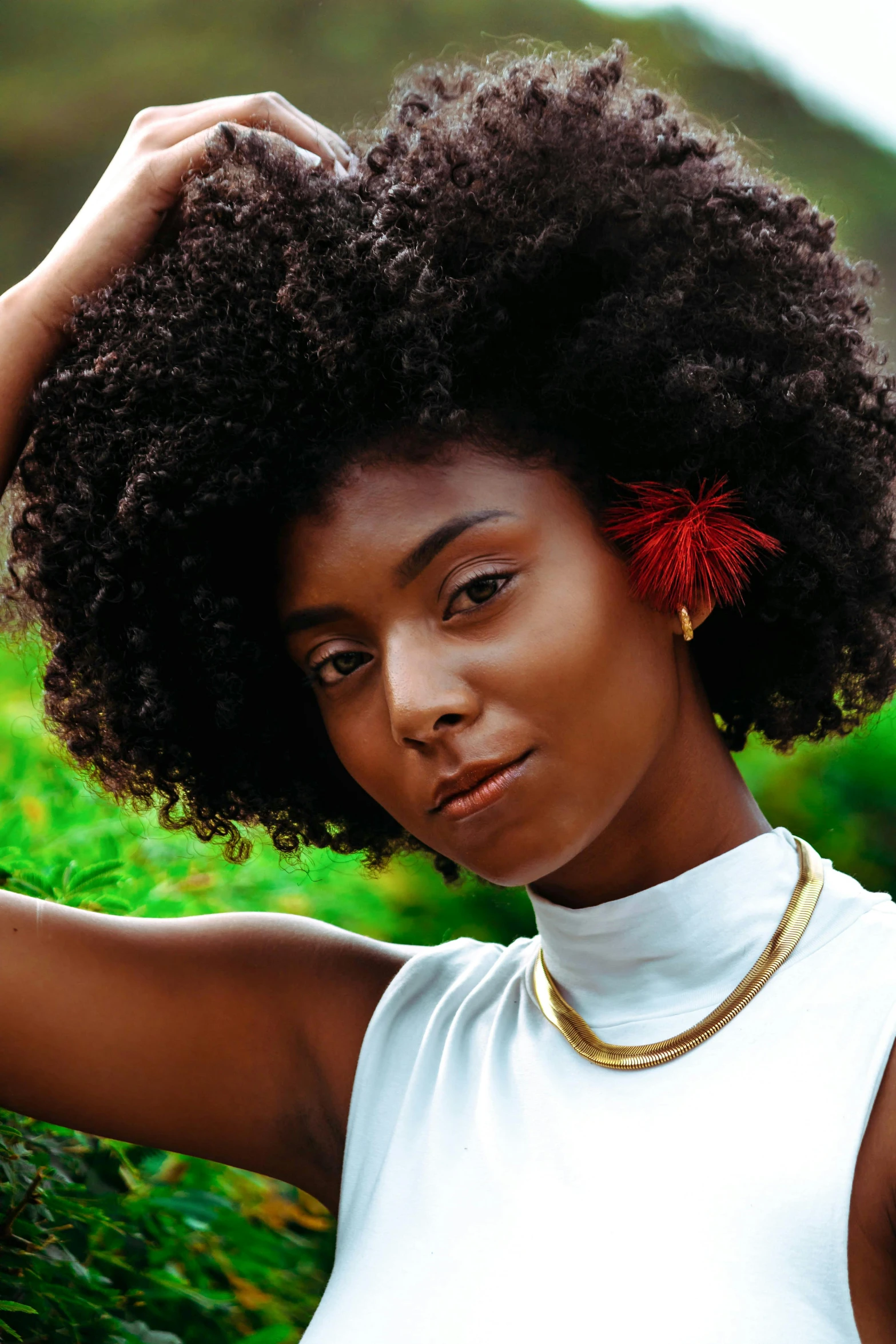 a black woman holding a afro in her hair