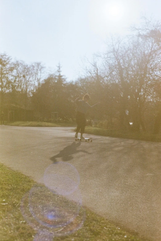 an skateboarder on the road in the morning