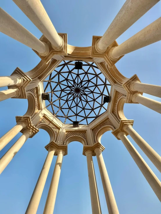 a white gazebo is set against the blue sky