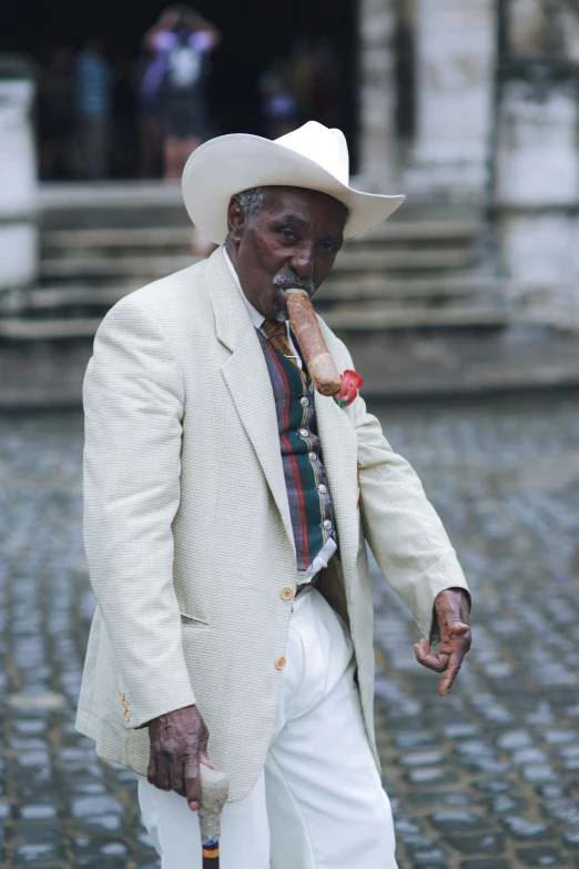 an old man is taking a stroll with a cane