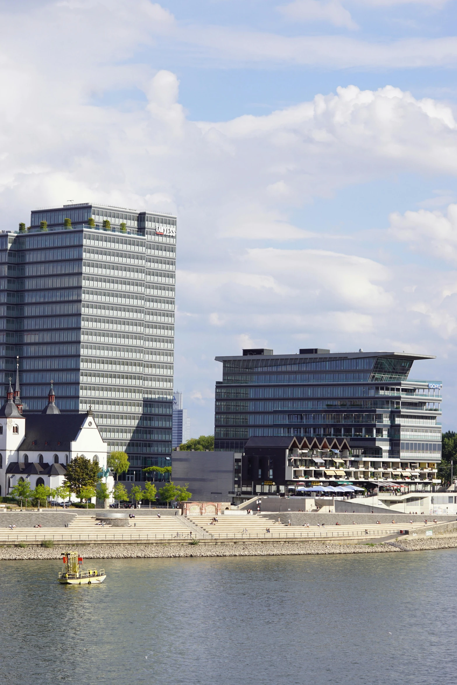 some buildings on the coast line by the water