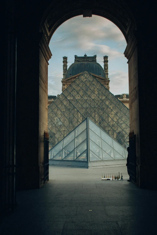 an entrance to a large glass pyramid in the center of a building