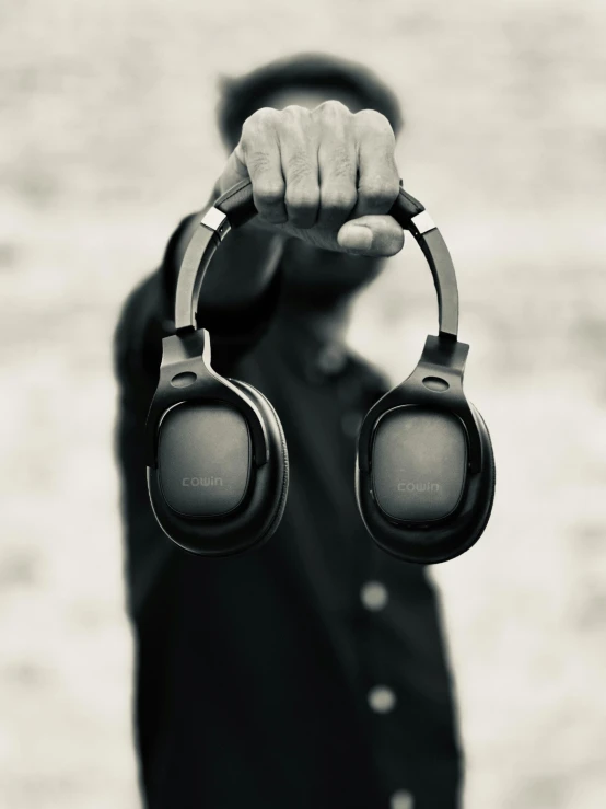 a man is holding onto some headphones