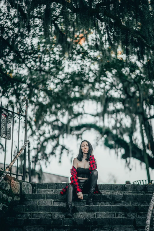 a woman in red is sitting on some stairs