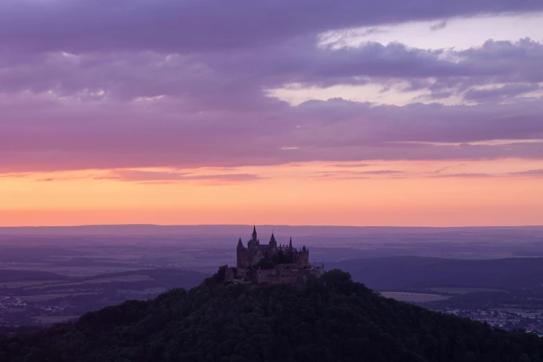 a castle sitting on top of a tall hill