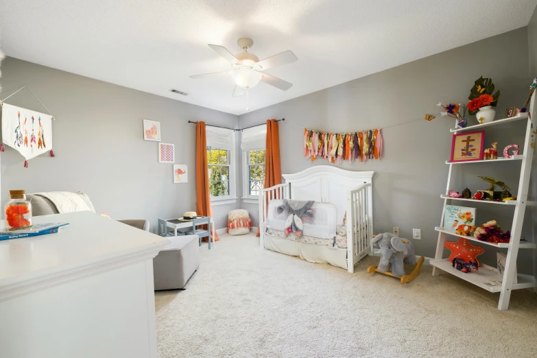 the nursery has a lot of shelves and decor in it