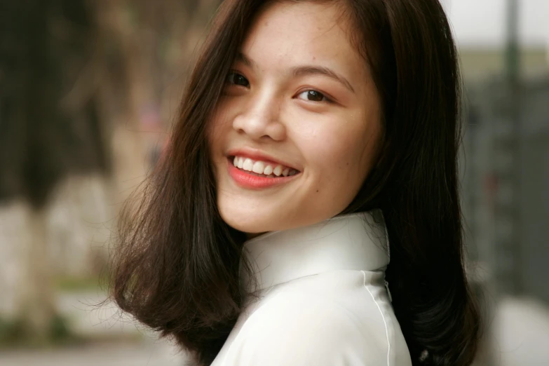 a pretty asian woman with brown hair and white shirt