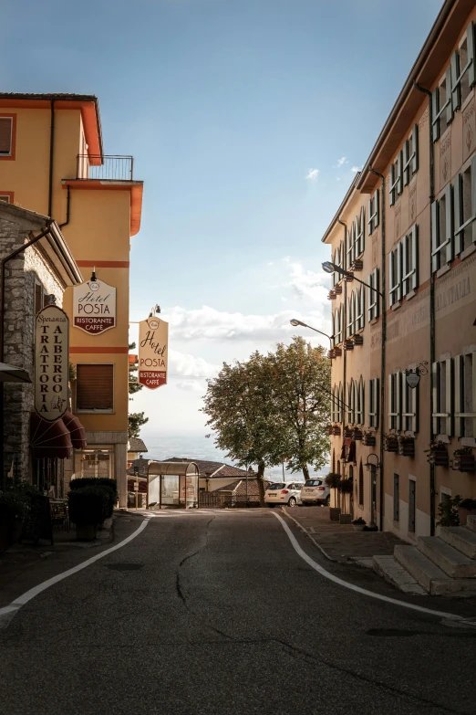 there is a street with tall brown buildings