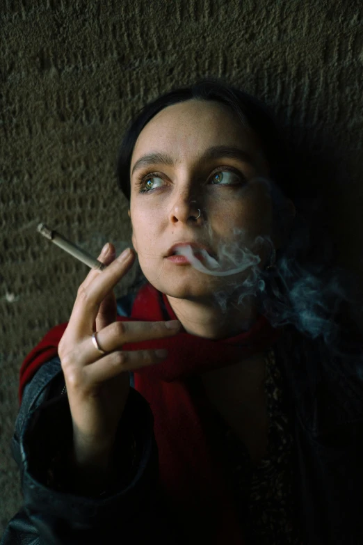 the woman smoking a cigarette has blue eyes