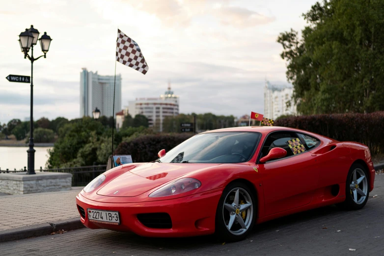 a red sports car with a checkered flag on its roof