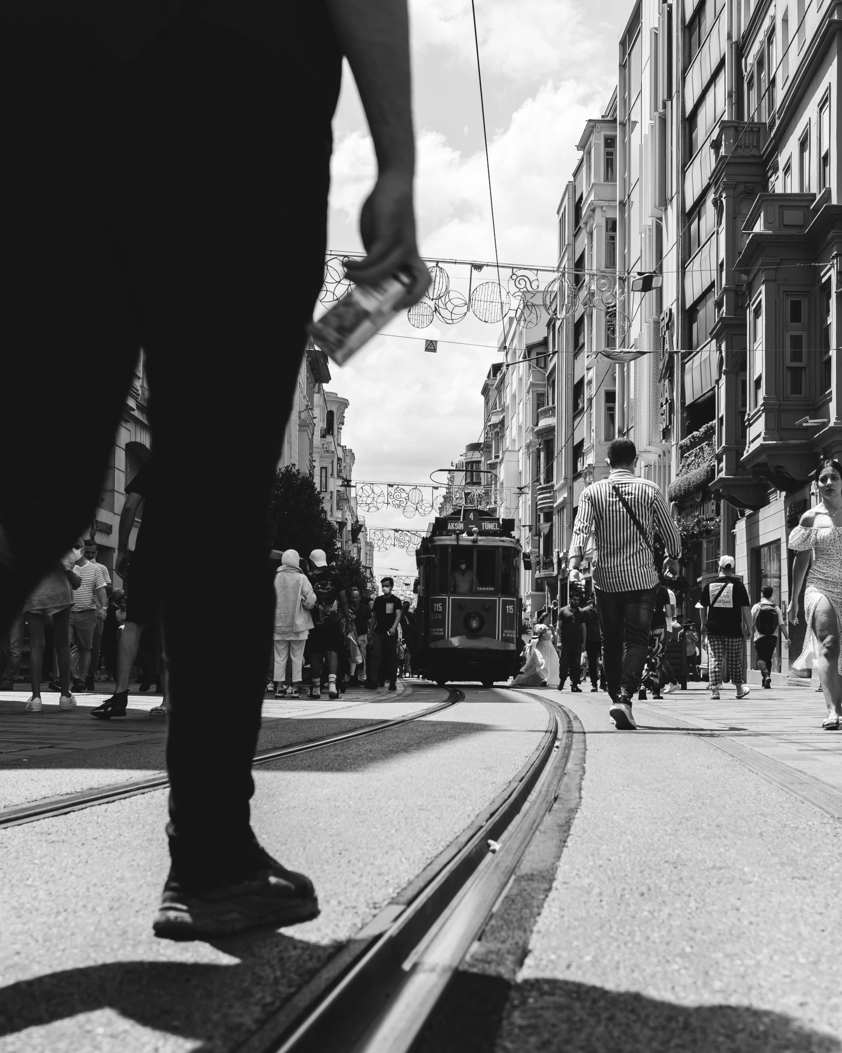 a black and white po of people walking in front of buildings