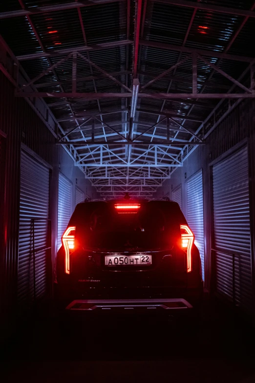 the back lights of a small dark car