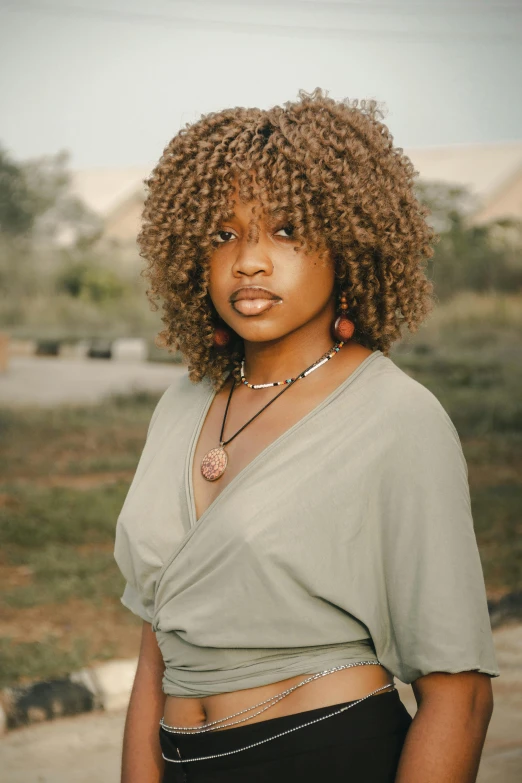 a woman with long hair standing in front of the camera