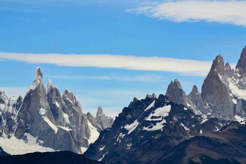 the snow capped mountains are in front of a blue sky