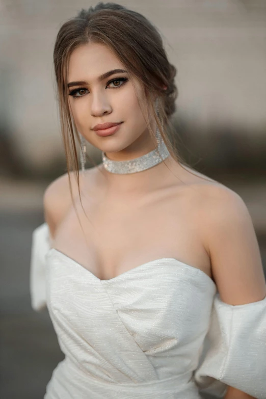 the woman is wearing a white dress and a choker neck