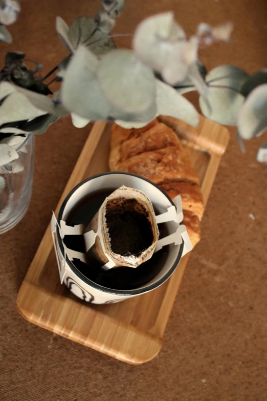 there is a bowl with bread inside and a pot next to it