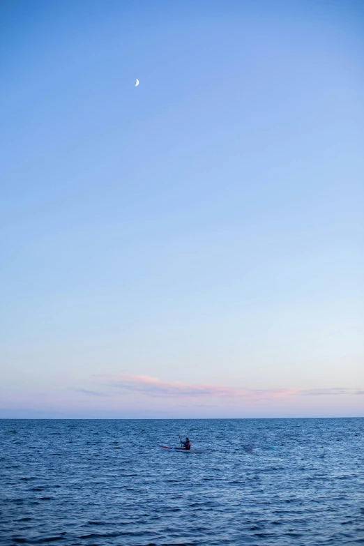 a lone boat in the distance near a small island