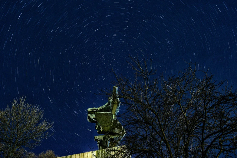 some stars in the night sky over an ornate street light