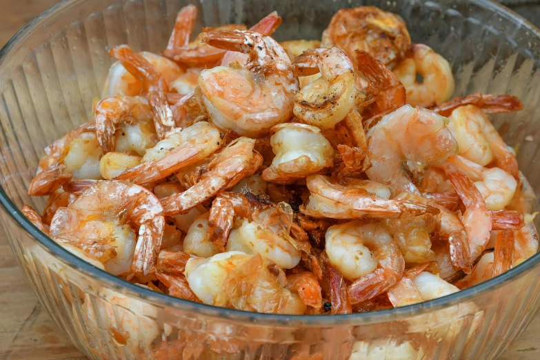 bowl full of shrimp sitting on top of a table