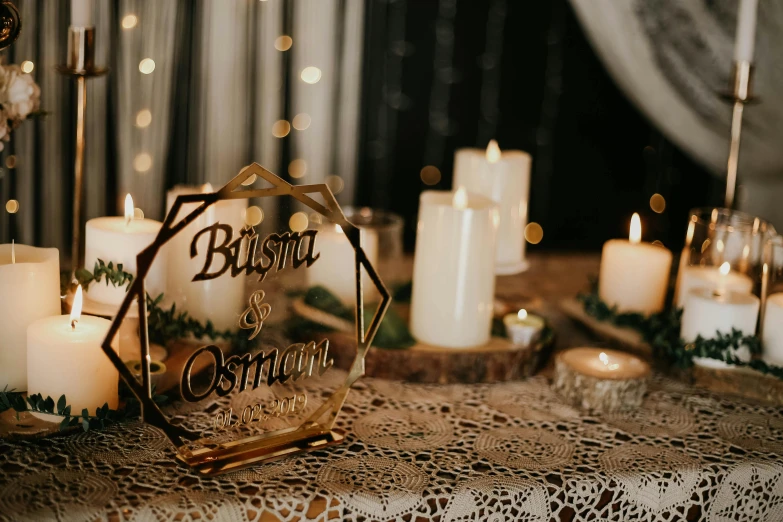 a table with candles, a sign, and ornaments on it