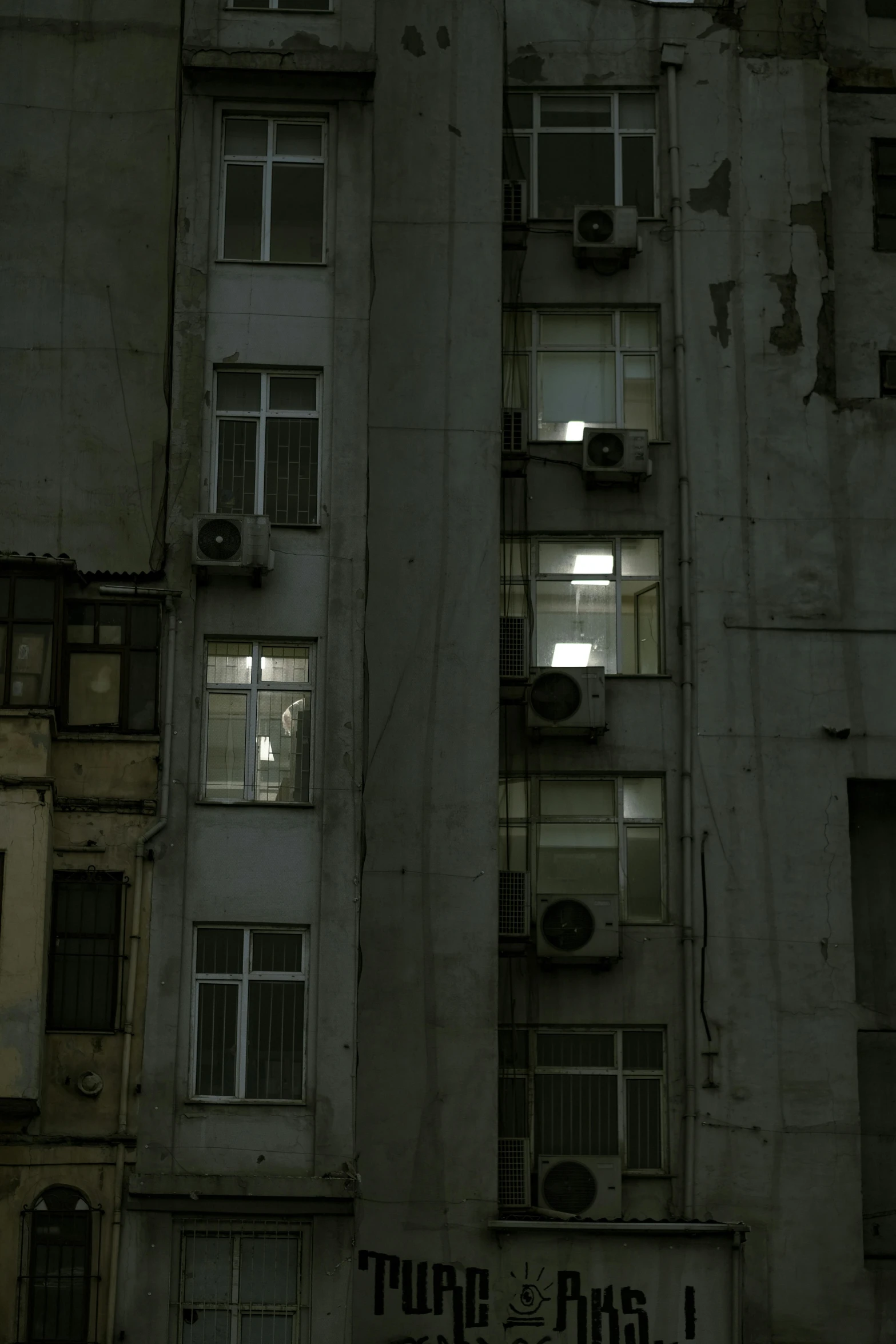 an abandoned building with some windows and lights