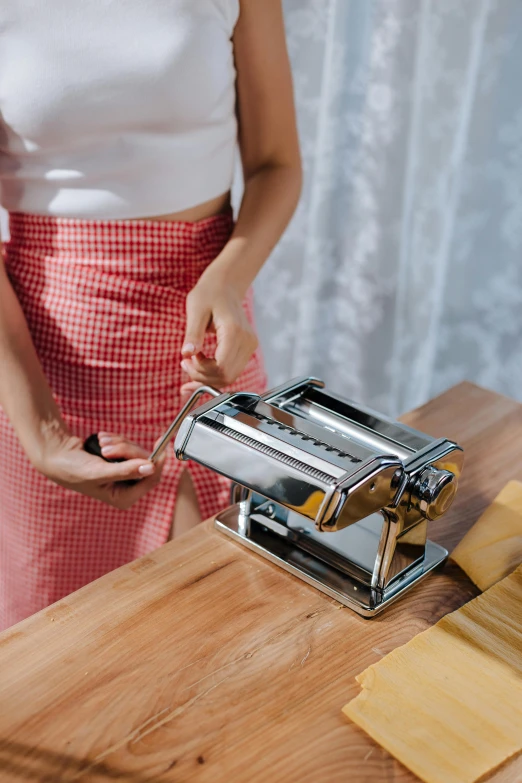 a person uses a vegetable slicer on a  board