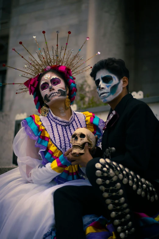 two people with face paint on sitting on a bench