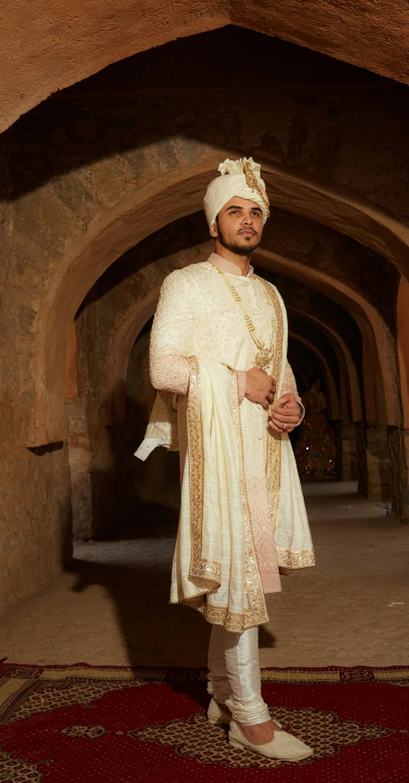 a man in white attire posing for the camera