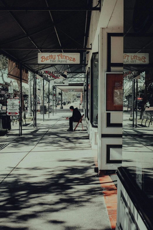 a person with a skateboard and some bus stop signs