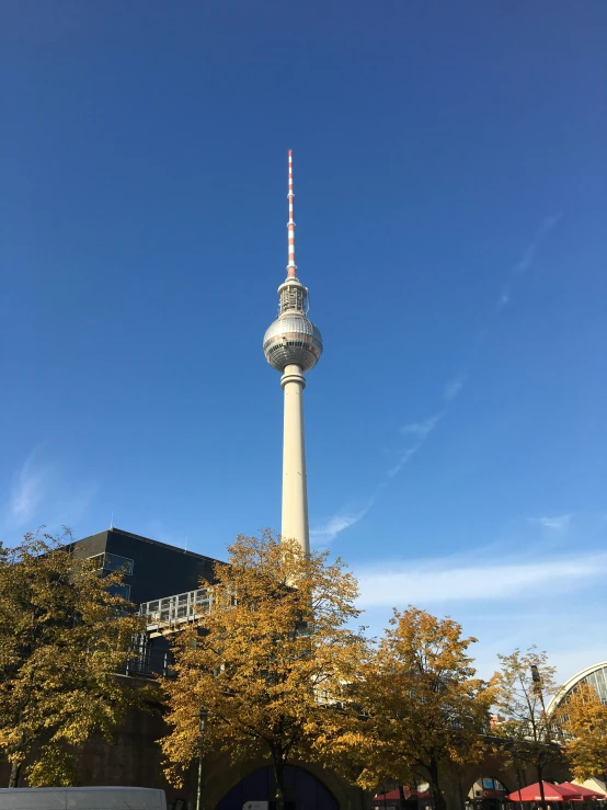 a very tall tower with a white sky background