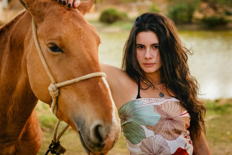 woman standing near a horse looking into the camera